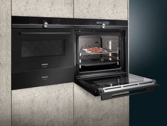 Dampfbackofen der Marke Siemens mit geöffneter Front und vakuumierten Gericht